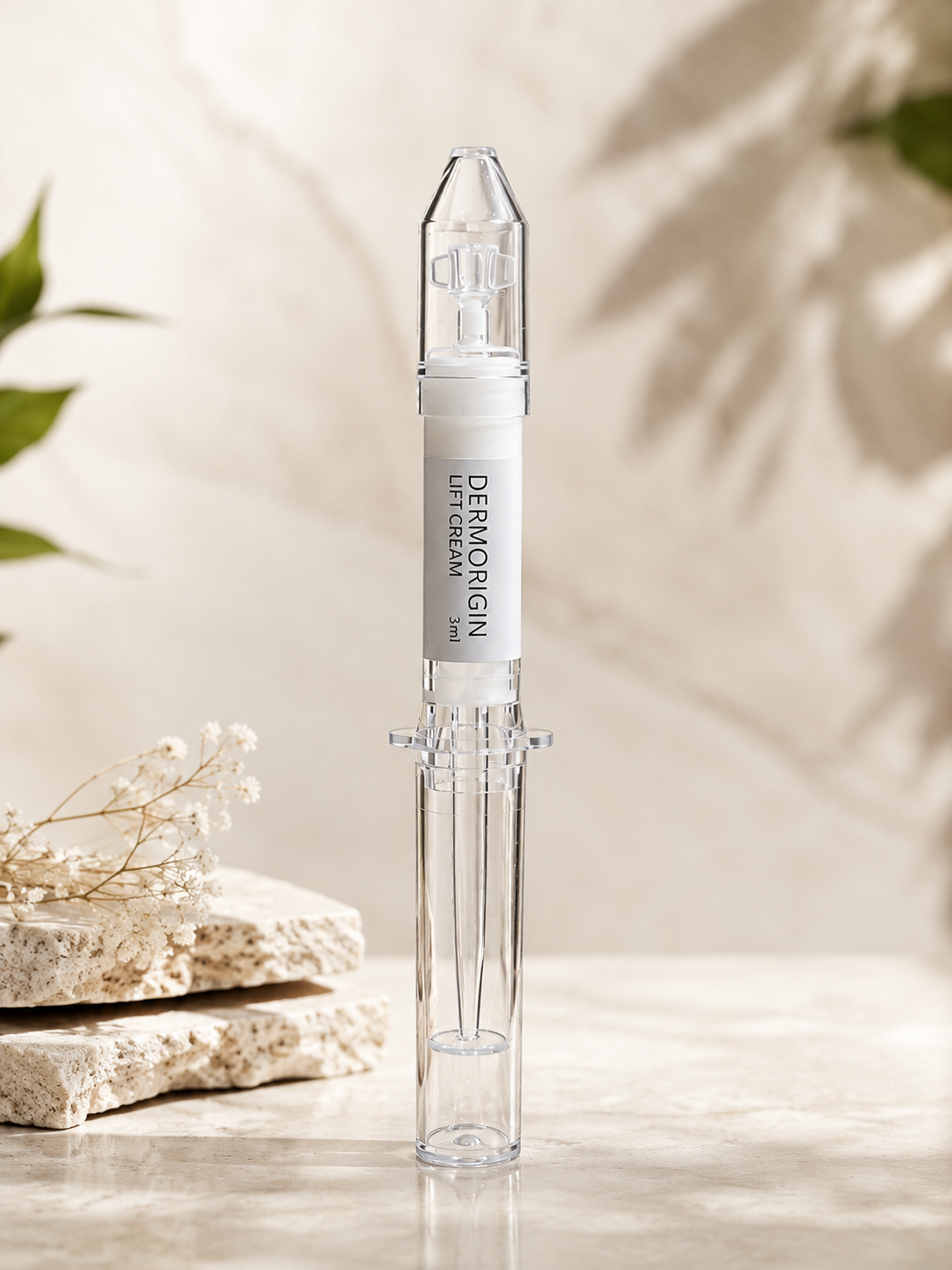 DERMORIGIN Lift Cream 3ml applicator syringe on marble with dried flowers